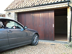 Vertically boarded side sectional garage door